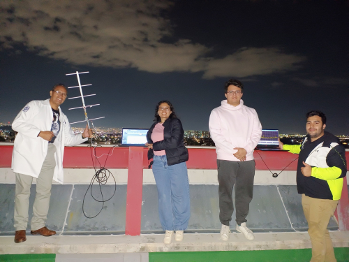 UNAM team on a rooftop with antennas